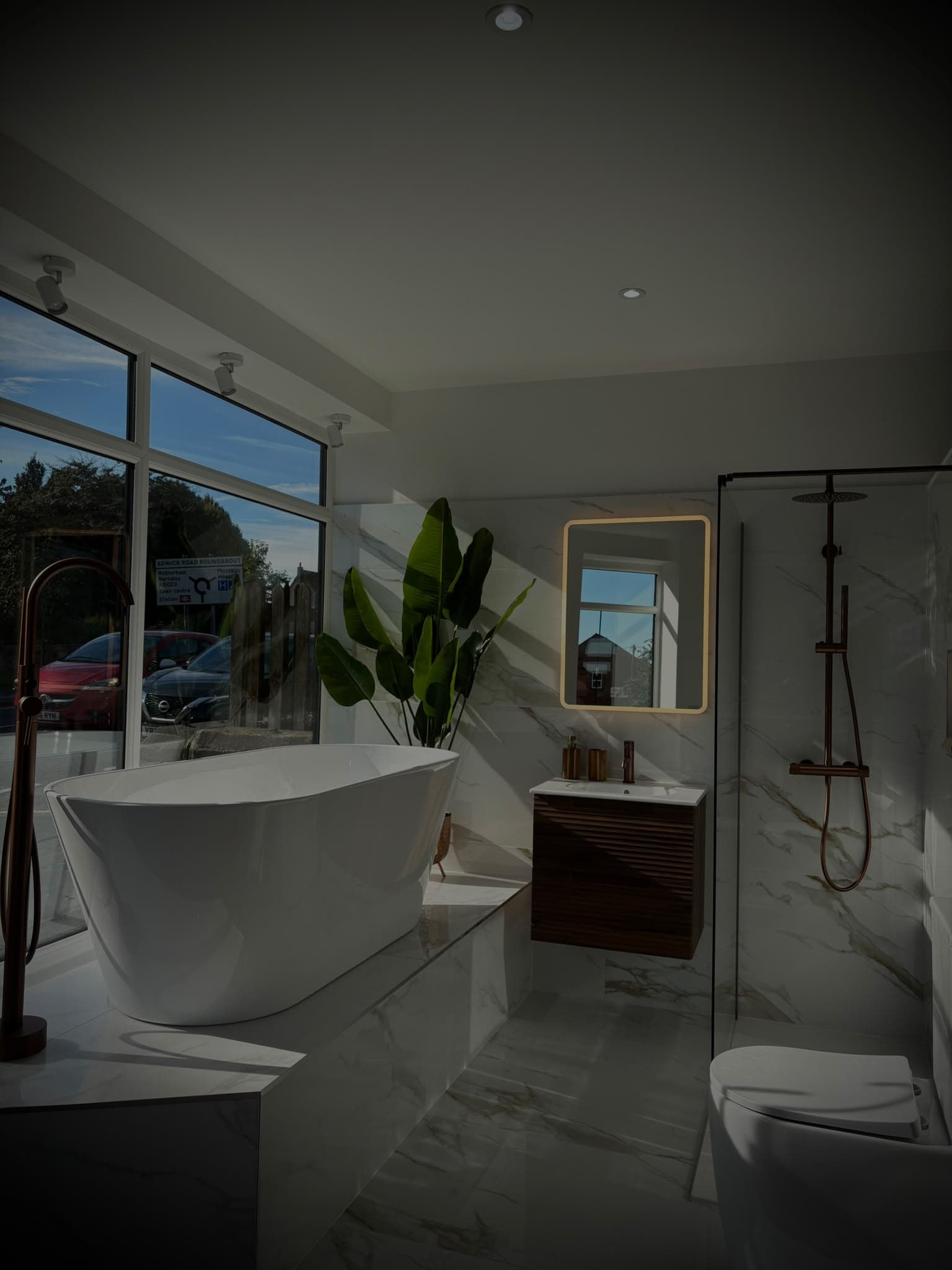 Inside the S64 Bathrooms showroom: freestanding bath, walnut vanity, LED mirror and copper walk-in shower