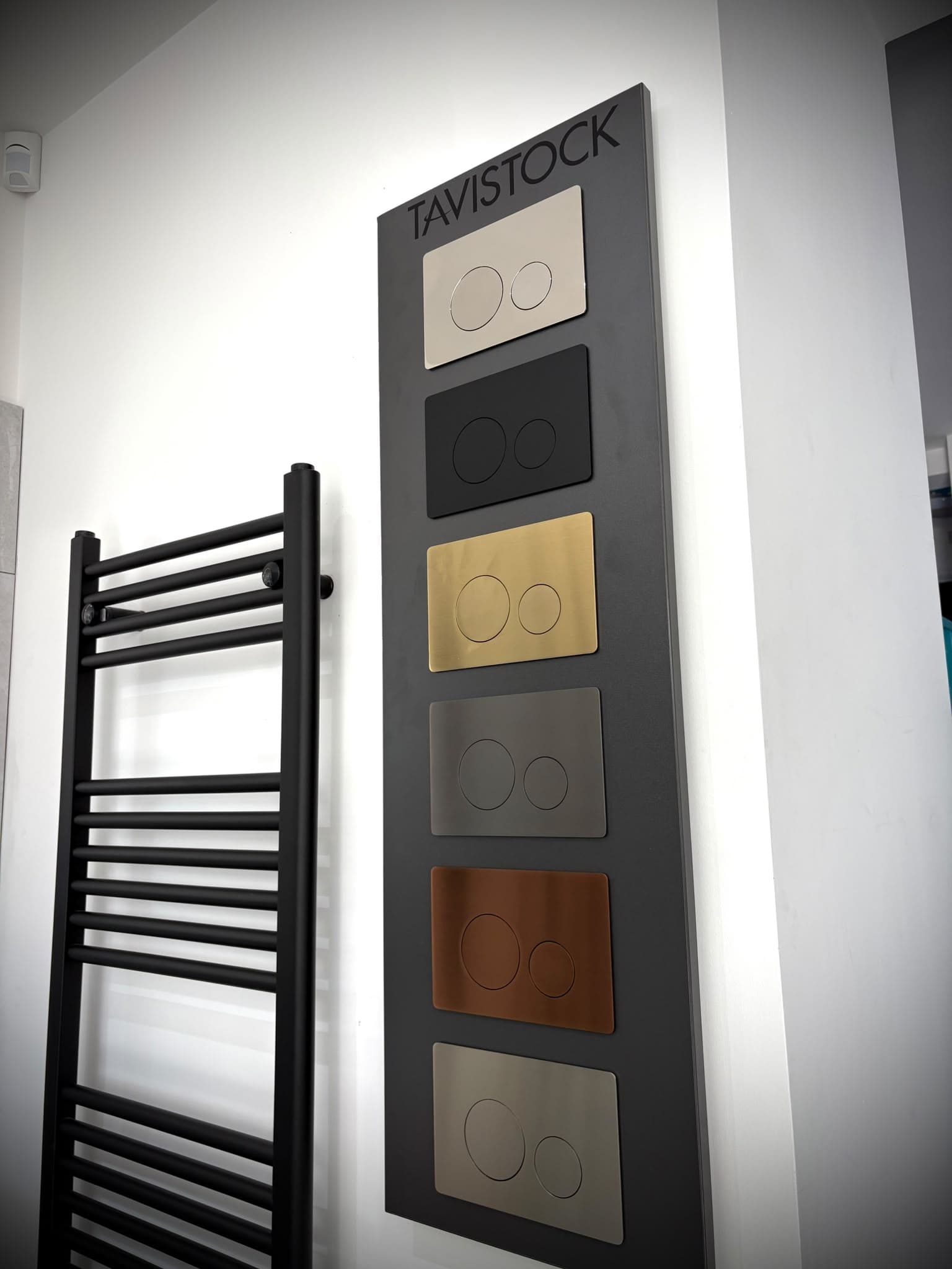 Tavistock flush plate display showing chrome, black, brass, gunmetal and copper finishes