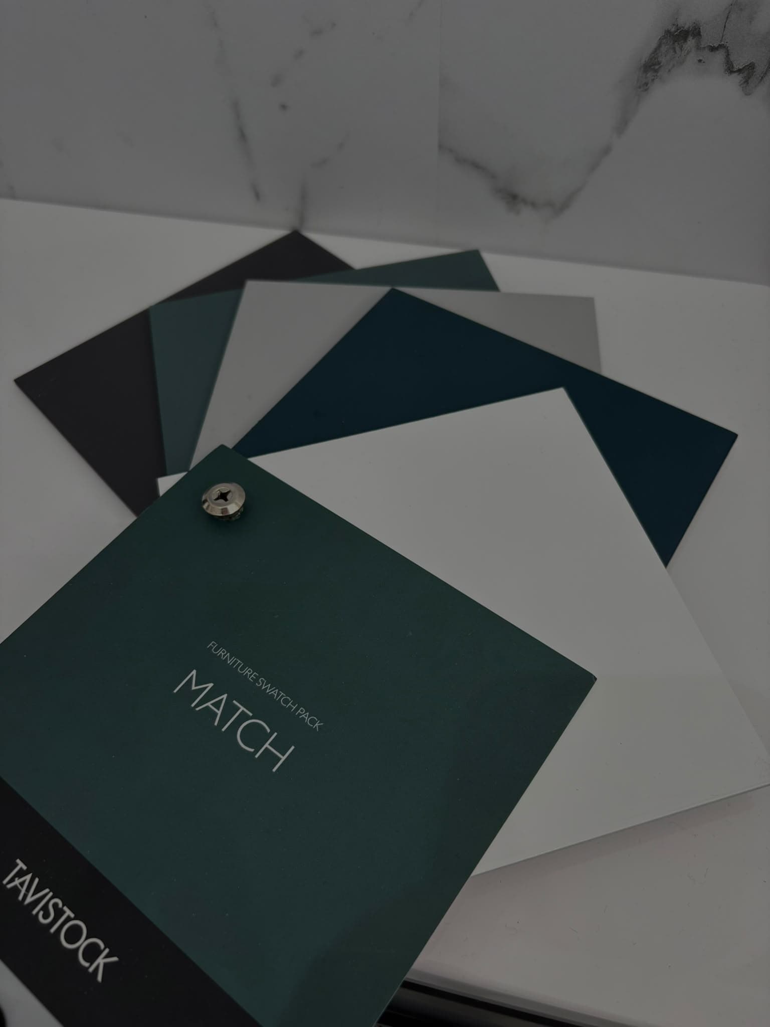 Tavistock furniture colour swatch pack on a marble worktop at the showroom