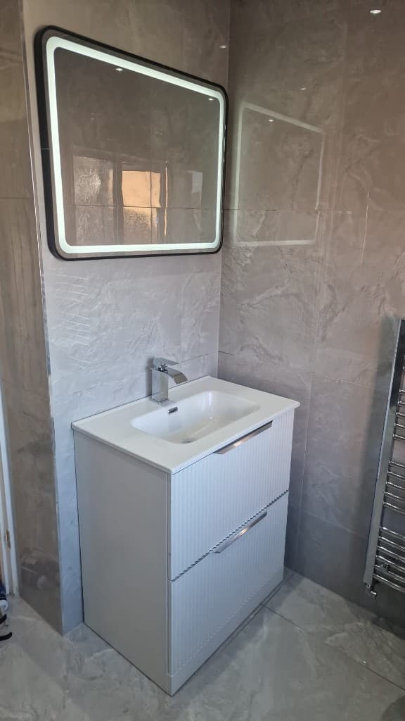 Modern vanity unit and LED mirror after bathroom fitting