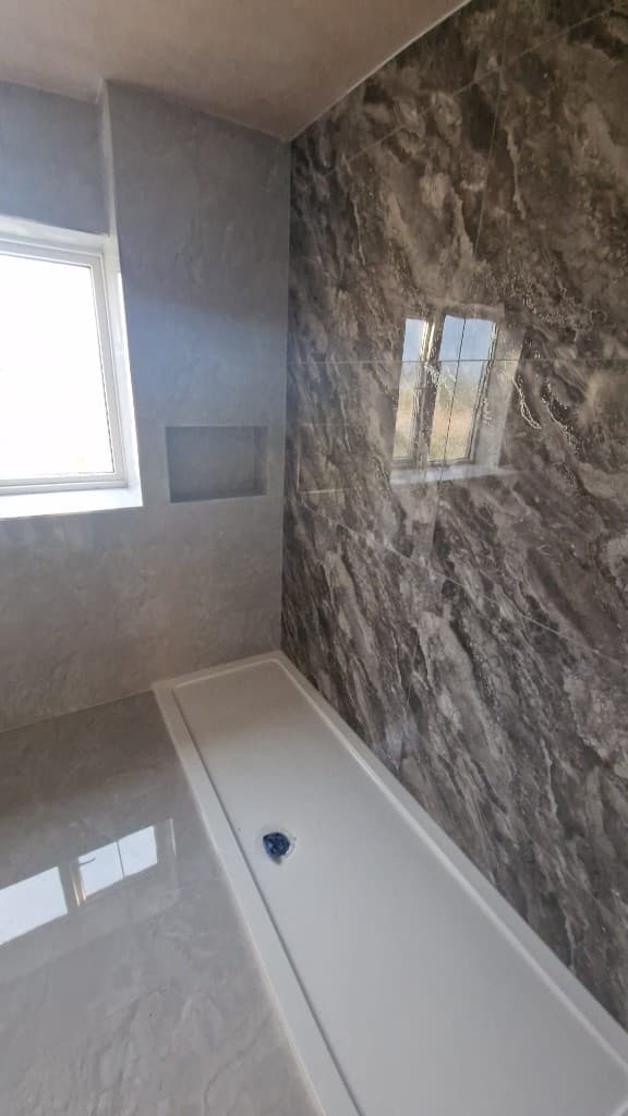 Wet-room style shower tray installation in bathroom renovation